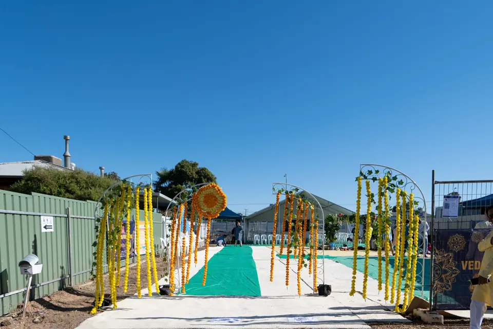Marigold arches over the green carpet leading onto the block