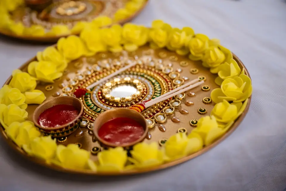 Pooja thali ringed with yellow roses